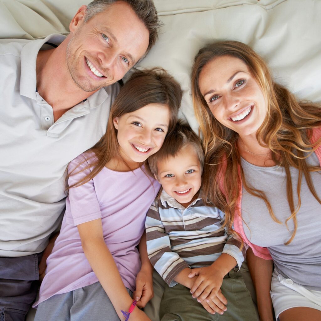 Happy times together. Portrait of a happy young family lying together on a bed.